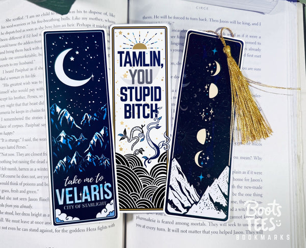A Court of Thorns and Roses (ACOTAR) bookmarks lay on an open book